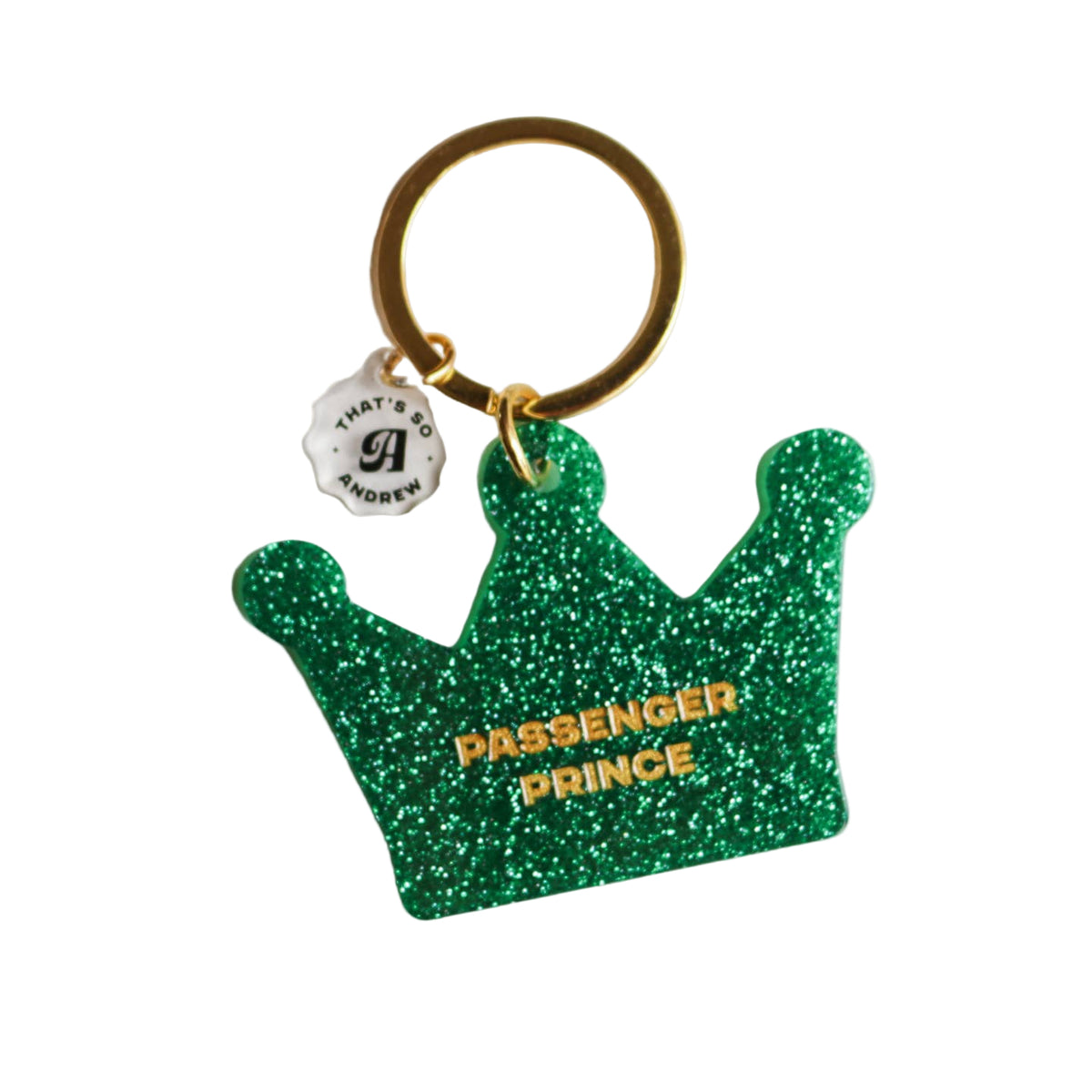 A green, glittery acrylic keychain in the shape of a crown with the text 'PASSENGER PRINCE' on it, attached to a metal keyring. 
