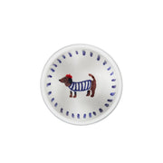 Small white plate with a dog illustration wearing a blue sweater on a white background