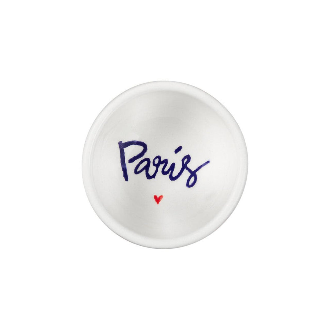 Small white dish with 'Paris' and a heart printed on it against a white background