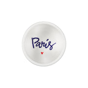 Small white dish with 'Paris' and a heart printed on it against a white background