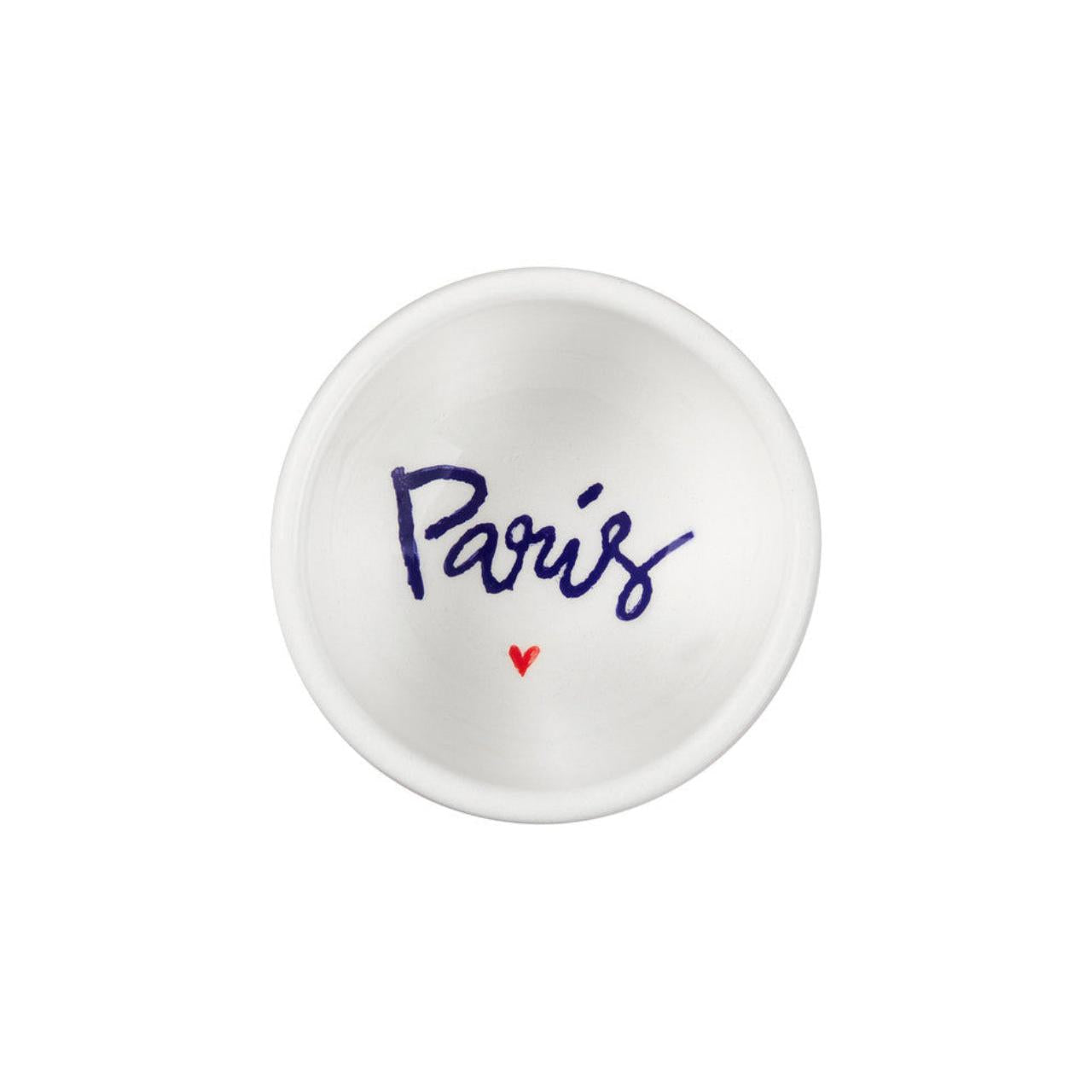 Small white dish with 'Paris' and a heart printed on it against a white background