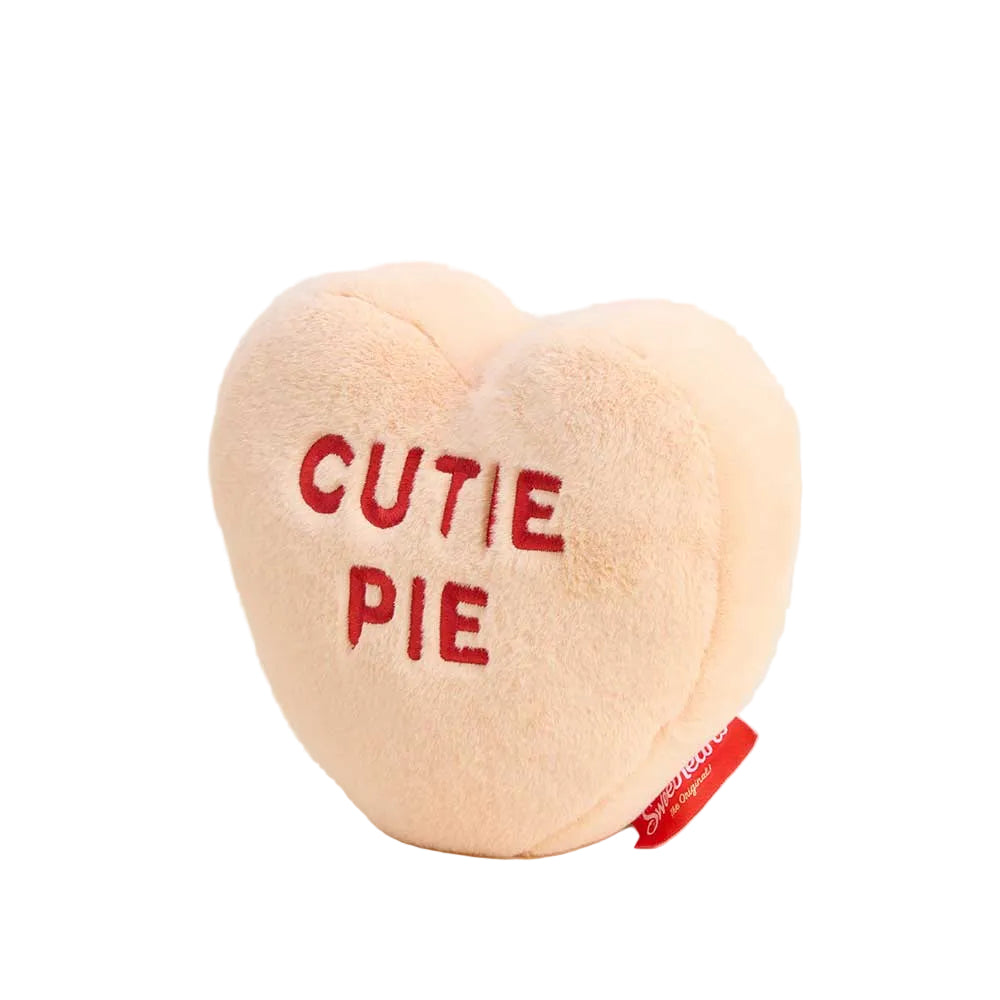 Heart-shaped plush toy with 'CUTIE PIE' text on a white background