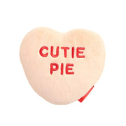 Heart-shaped pillow with 'CUTIE PIE' text on a white background