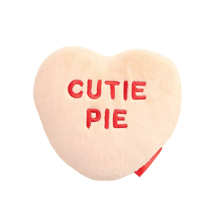 Heart-shaped pillow with 'CUTIE PIE' text on a white background