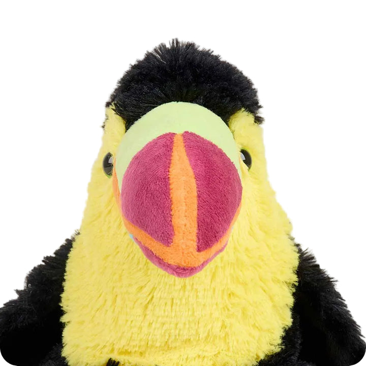 Plush toy resembling a toucan with a yellow face and black head on a white background